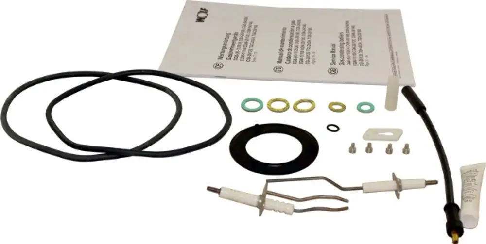 Wartungsset von Wolf mit verschiedenen O-Ringen, Dichtungen, Montageschrauben und einer Anleitung, das für Reparaturen und Wartung von Heizgeräten verwendet wird.